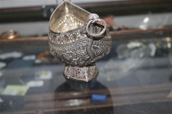 An Indian? white metal oval bowl with ring handles and three other items including two filligree items.